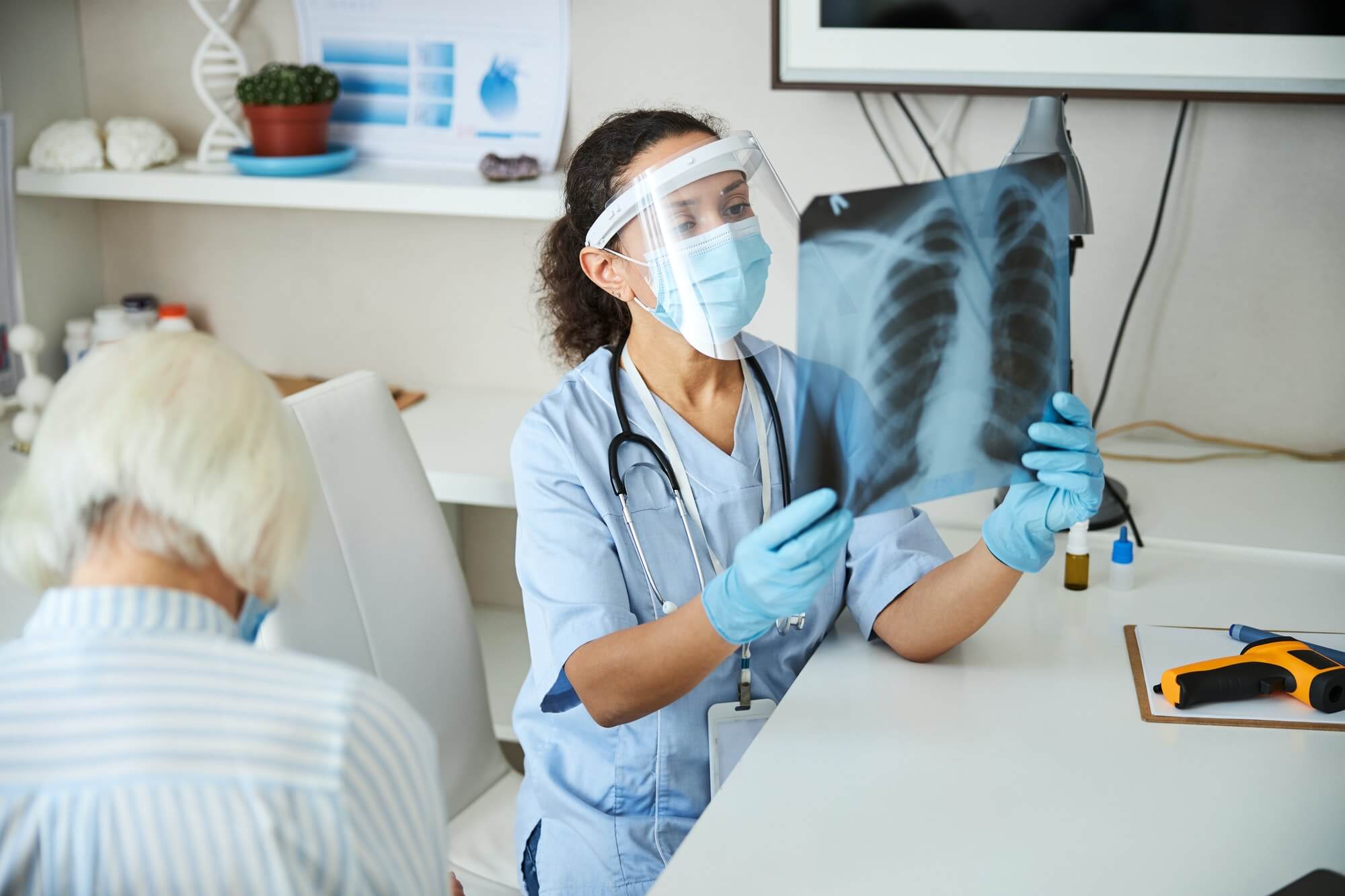 Woman hospital specialist holding a chest radiograph